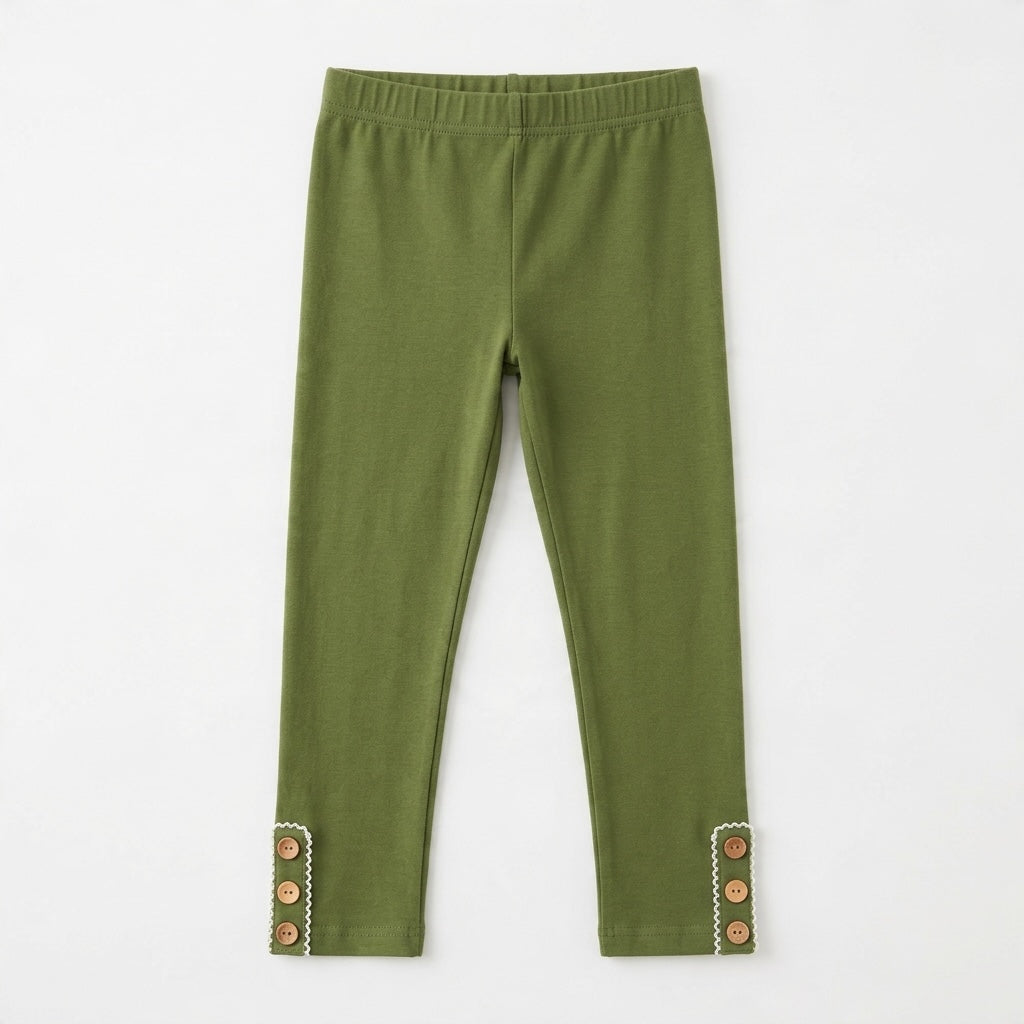 Green Swoon toddler leggings in olive green with decorative wooden buttons and white trim at the cuffs.