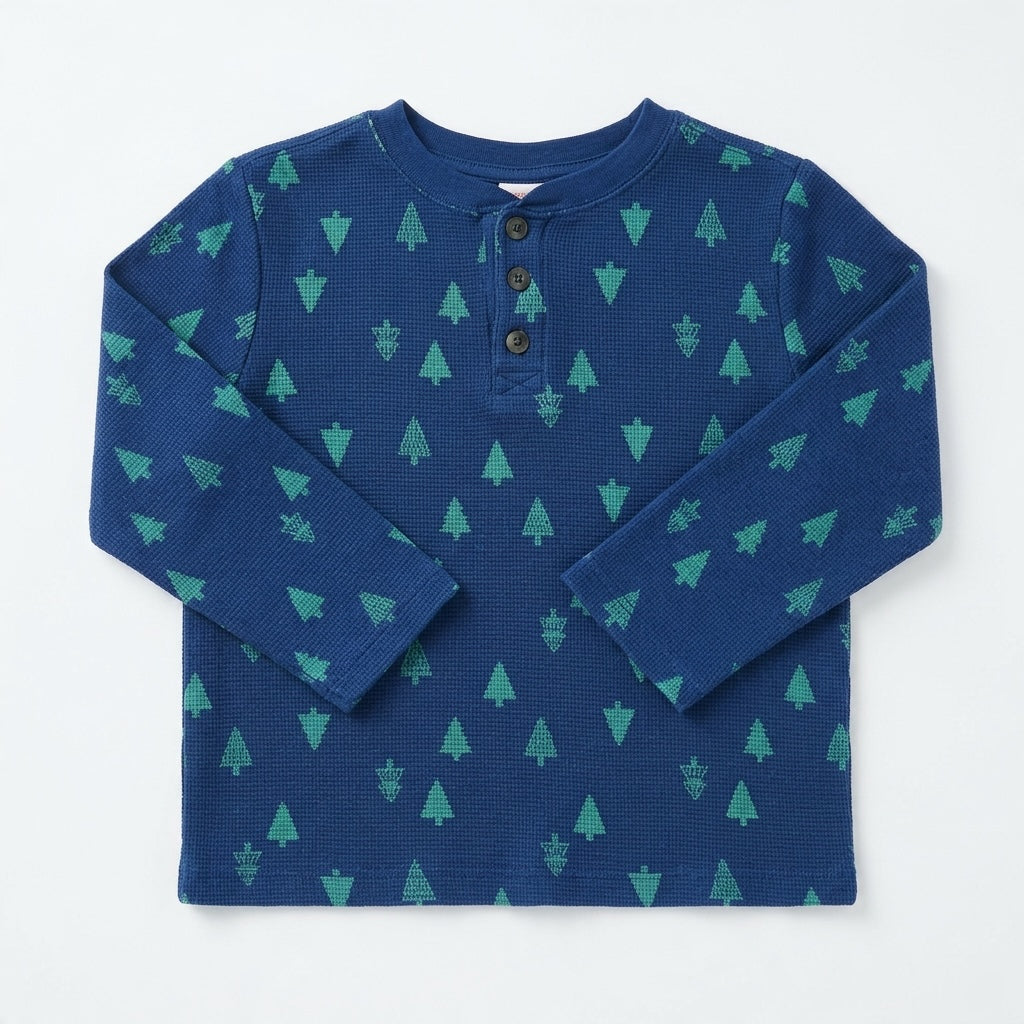 Hanna Andersson navy blue waffle knit long-sleeve shirt with green pine tree pattern and three-button henley placket.