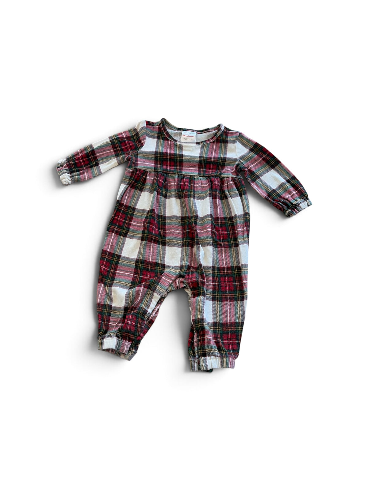 Hanna Andersson baby one-piece in a red, white, and green plaid pattern with long sleeves and gathered cuffs.