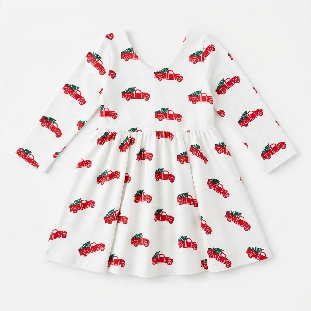 Monica + Andy toddler dress in white with a red truck and Christmas tree print, featuring long sleeves.
